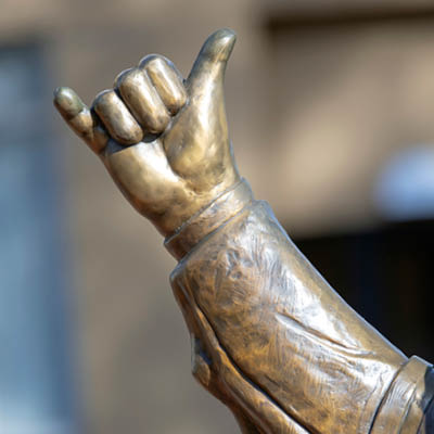 A close up of the spurs up portion of the Cocky statue.