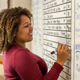 Person writing on a whiteboard 