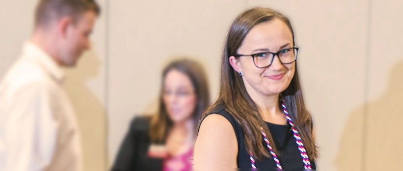 student smiling after receiving graduation cords