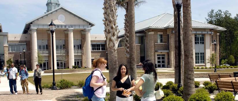 Hargray Building on USC Beaufort campus, with small clusters of students standing out front talking