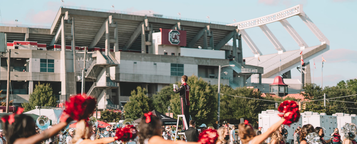 Gamecock cheerleaders cheering in front of Williams-Brice stadium