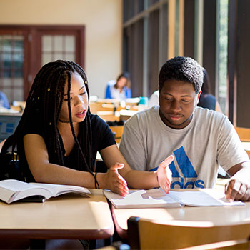 Students at a table studying together.