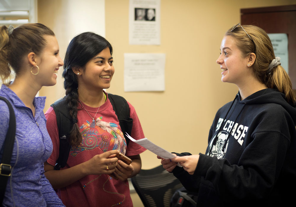 Three Honors College students talking in the Honors College residence.