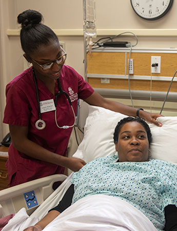 a student nurse adjusts a pillow for a patient in a hospital setting