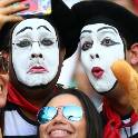 Student holding baguette and taking a selfie with a sad mime.