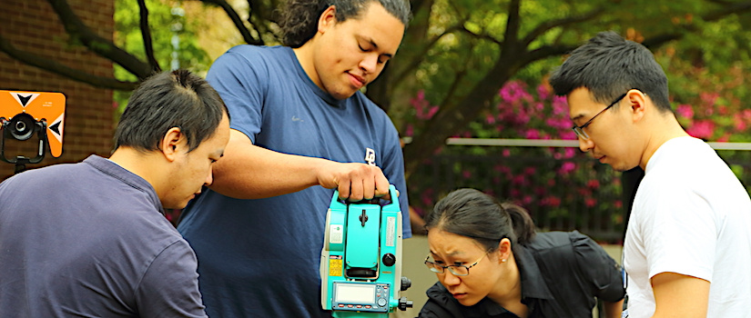 Grad students setting up a surveying project with the Total Station