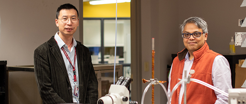 Lang Yuan and Tanvir Farouk stand in a lab.