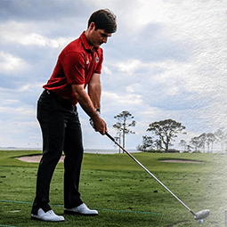 Ben Dietrich takes a swing on a golf course at UofSC