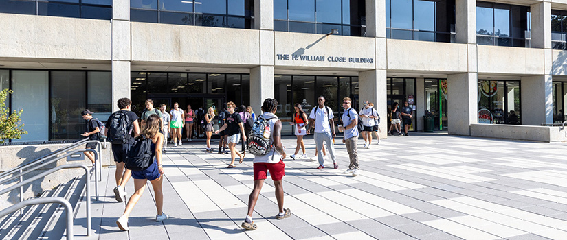 Front entrance of Close-Hipp with students walking around