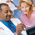 doctor and nurse reviewing information on a computer screen