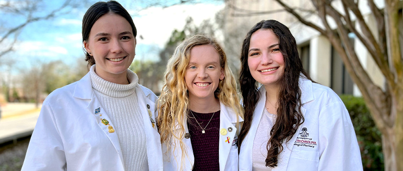 Three students in white coats