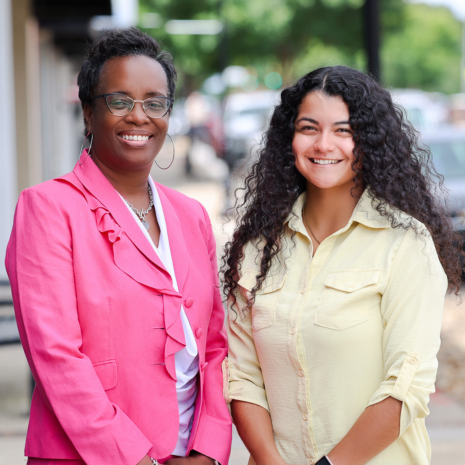 two community helath works standing and smiling at the camera