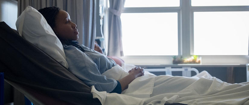 Black woman in hospital bed