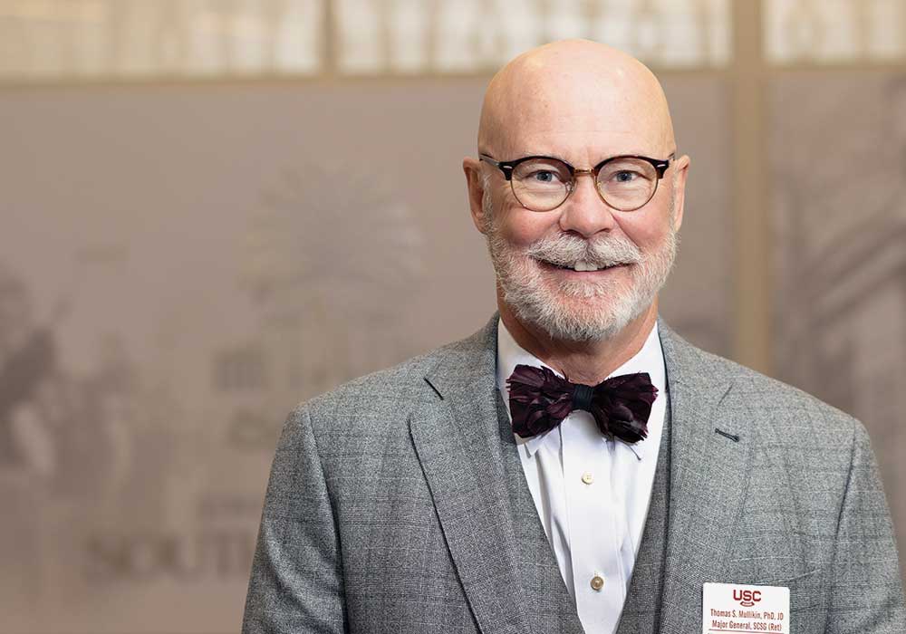 Tom Mullikin smiles for the camera wearing a bowtie.