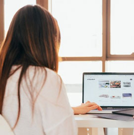 woman sits in front of computer screen