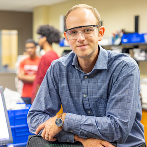 morgan stefik wears safety glasses as he teaches a lab class