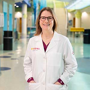 USC professor and alumna Anna Hoppmann stands in the atrium of the children's hospital at Prisma Health-Midlands. 