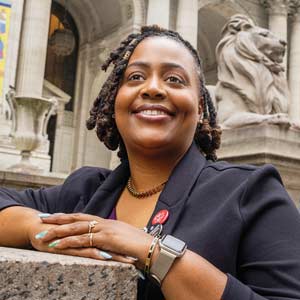 Sharita Sims stands in front of the New York Public Library.