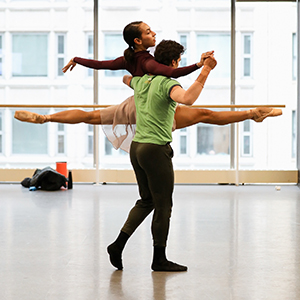 Dancers in studio perform a lift 