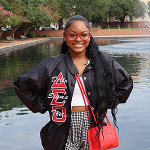 Zoe McDonald stands in front of library fountain