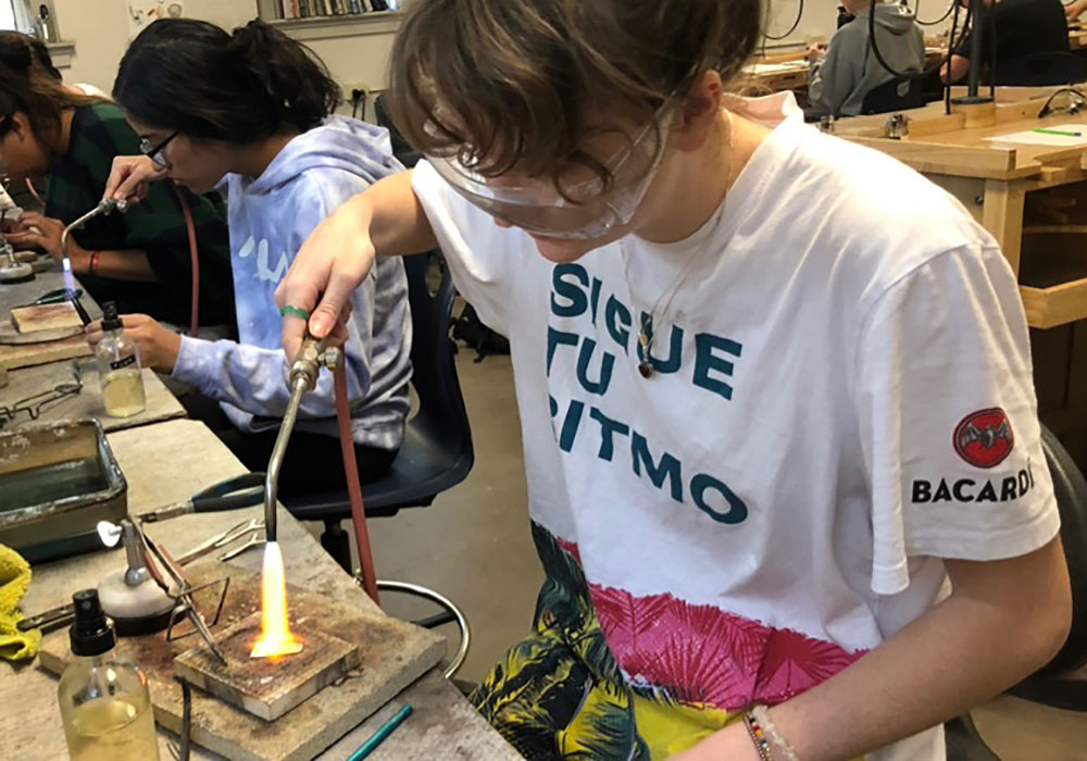students using blowtorches